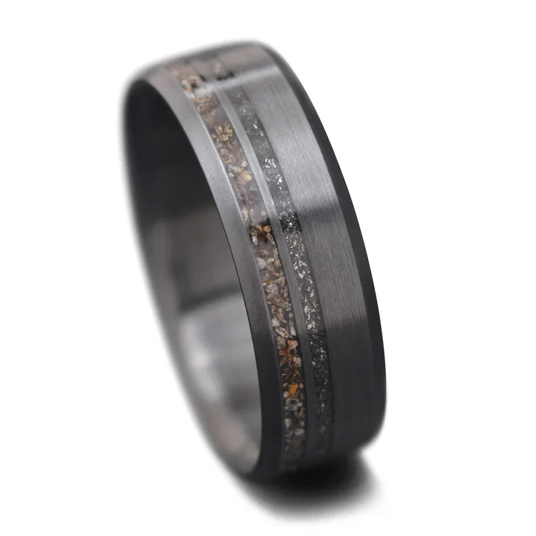Zirconium wedding band with crushed T-Rex and meteorite inlays, free engraving, 7mm mens ring with unique brushed bevel profile on white background.
