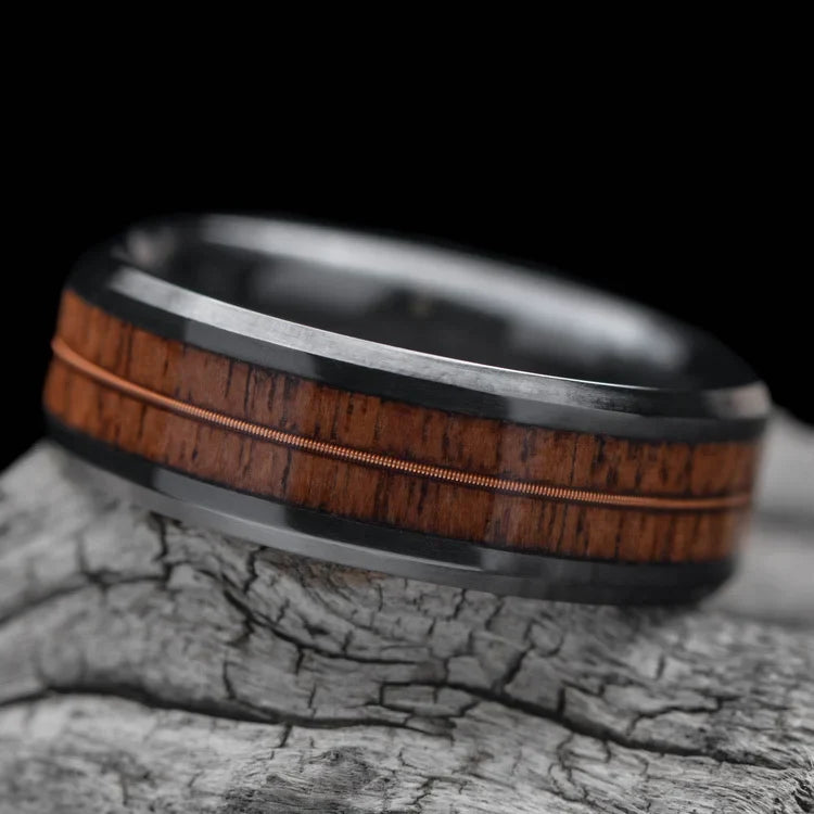 Black titanium wedding band with dual walnut and guitar string inlays, 8mm mens ring, polished bevel profile, displayed on a white sea branch, free engraving available.