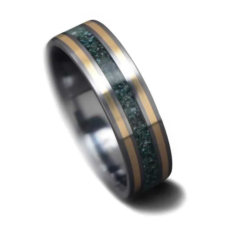 Tantalum wedding band with dual 14K yellow gold inlays and moss agate center, featuring a custom brushed finish, 6mm mens ring on white background, free engraving available.