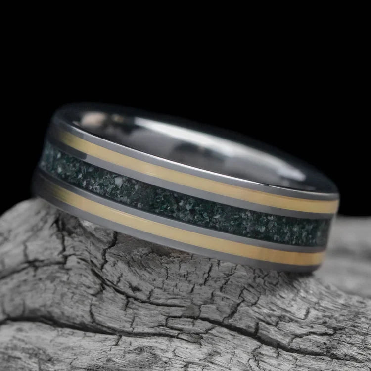 Tantalum wedding band with dual 14K yellow gold inlays and moss agate center, custom brushed finish, 6mm mens ring, free engraving, displayed on white sea branch.