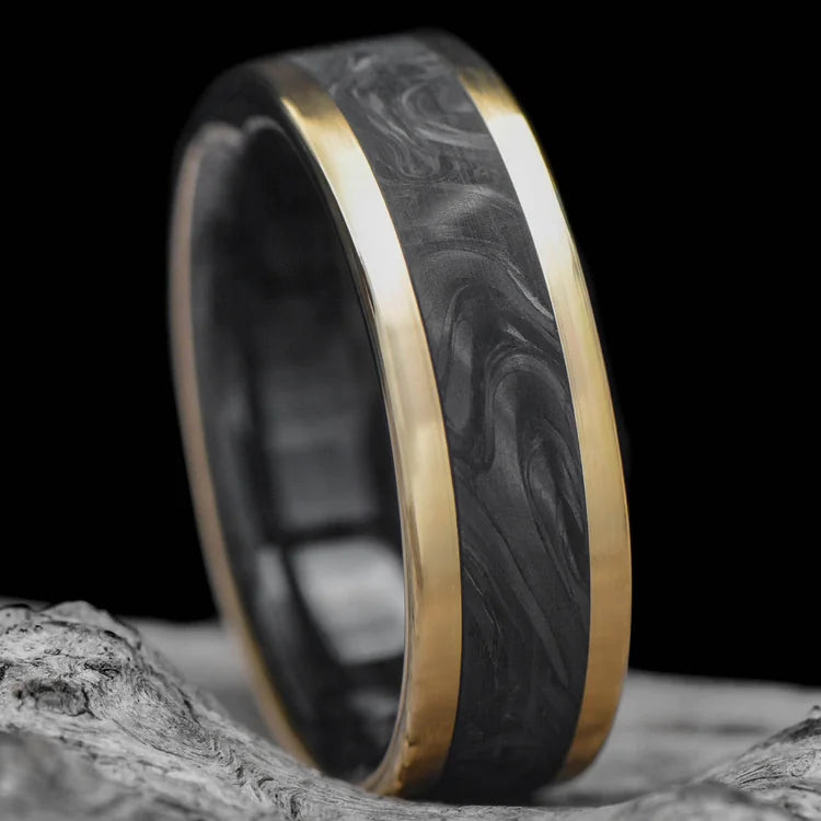 14KY gold mens wedding band with central forged inlay and forged inner sleeve, brushed flat profile, 7mm width, free engraving, displayed on a white sea branch.
