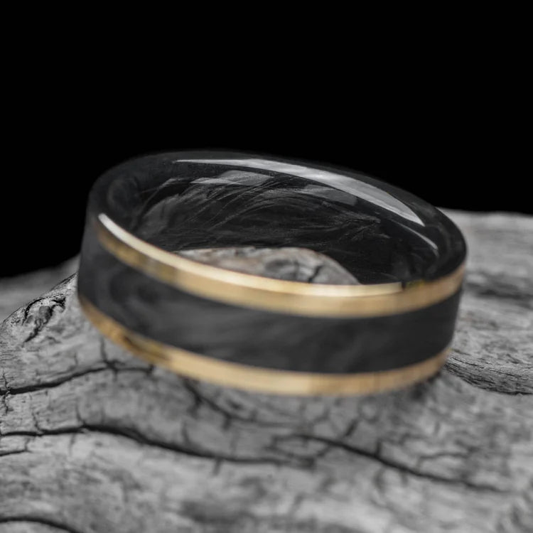 14KY gold mens wedding band with central forged inlay and forged inner sleeve, brushed flat profile, 7mm, free engraving, displayed on a white sea branch.