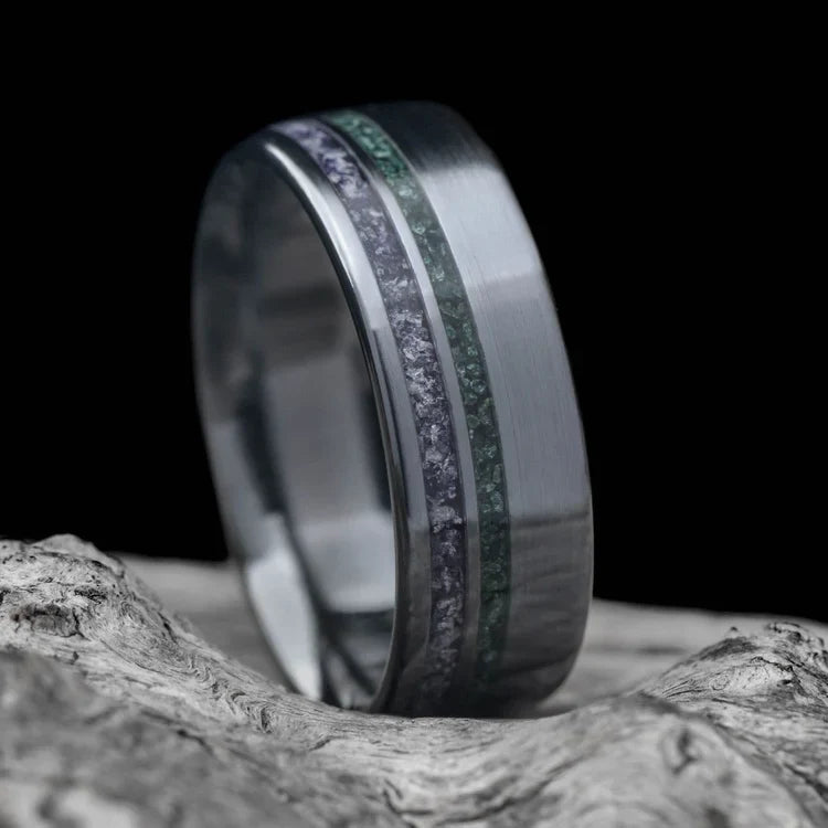 Black titanium wedding band with amethyst and moss agate inlays, 7mm mens ring, unique design, free engraving, displayed on a white sea branch.