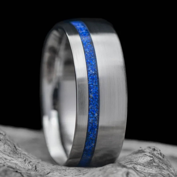 Titanium wedding band with lapis lazuli inlay, 8mm mens ring, brushed domed profile, custom design, free engraving, displayed on white sea branch.