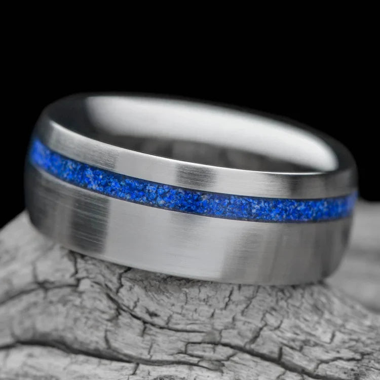 Titanium wedding band with lapis lazuli inlay, 8mm mens ring, brushed domed profile, custom design, free engraving, displayed on white sea branch.