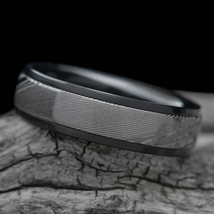 Zirconium mens wedding band with central dense twist inlay, polished domed profile, 7mm width, unique design, free engraving, displayed on a white sea branch.