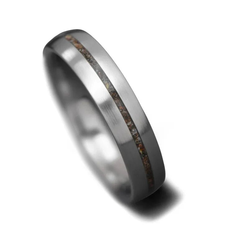 Titanium wedding band with central crushed T-Rex inlay, 5mm width, featuring free engraving, simple custom design, unique wedding ring on white background.
