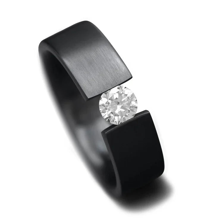 Black titanium mens wedding band with tension set diamond, 7mm brushed flat profile, free engraving available, displayed on a white background.