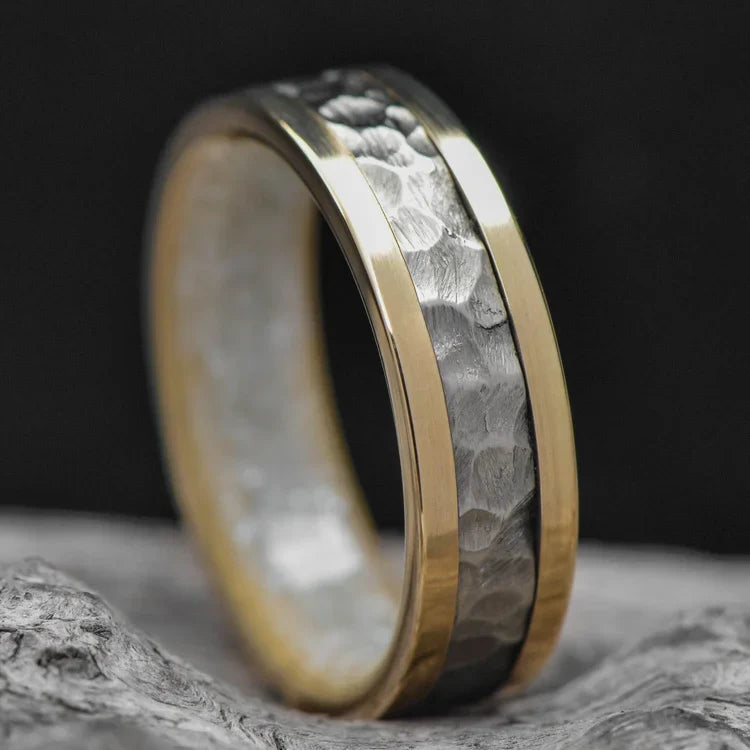 14KY gold wedding band with central 14KW gold inlay, featuring a pearl inner sleeve and a hammered flat profile, laying on a white sea branch; mens 6mm unique ring with free engraving option.