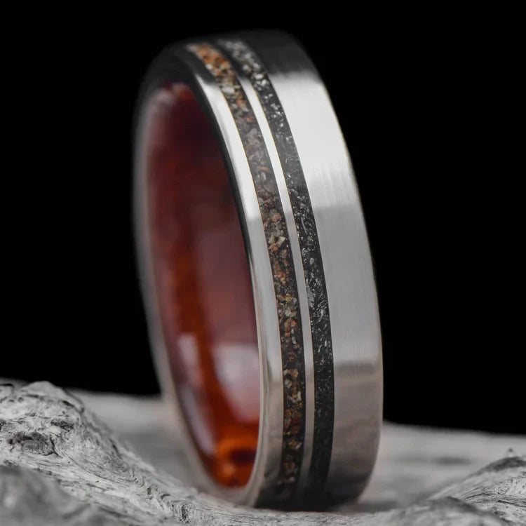 Titanium wedding band with crushed T-Rex and Western Maple Burl inlays, 6mm mens ring, unique custom design, free engraving, displayed on a white sea branch.