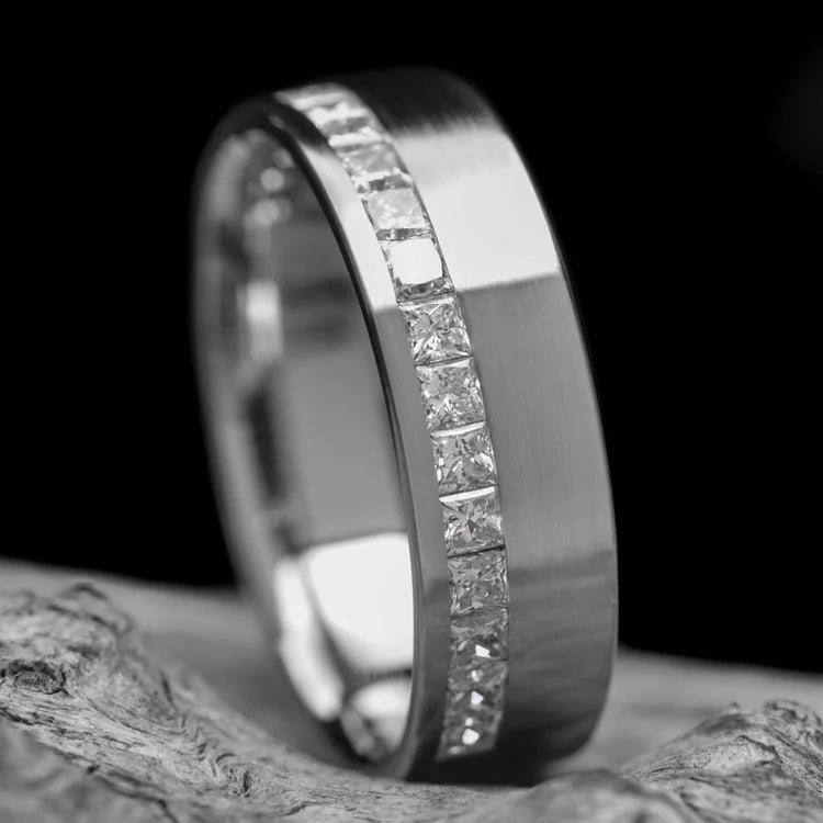Mens 10KW brushed flat wedding band with half eternity princess cut stones, 7mm, custom design, free engraving, displayed on white sea branch.