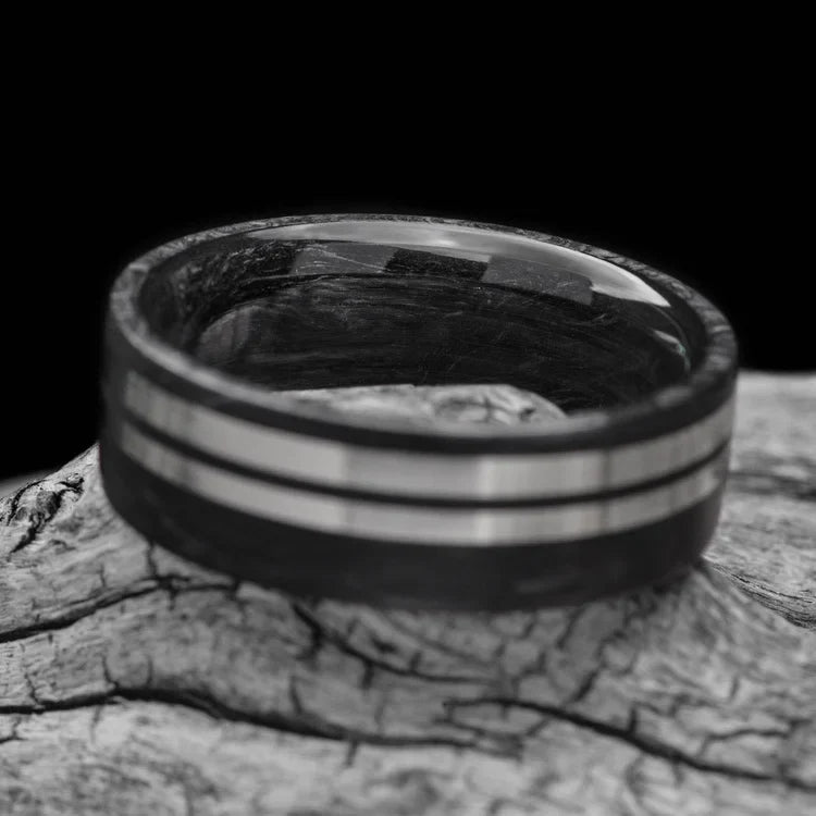 Mens wedding band with dual 14KW inlays, brushed flat profile, 7mm width, custom forged ring with free engraving, displayed on a white sea branch.