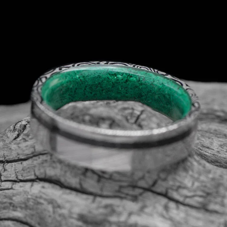 Heimskringla wedding band with meteorite and malachite inlays, 6mm mens unique custom ring, free engraving, displayed on white sea branch.