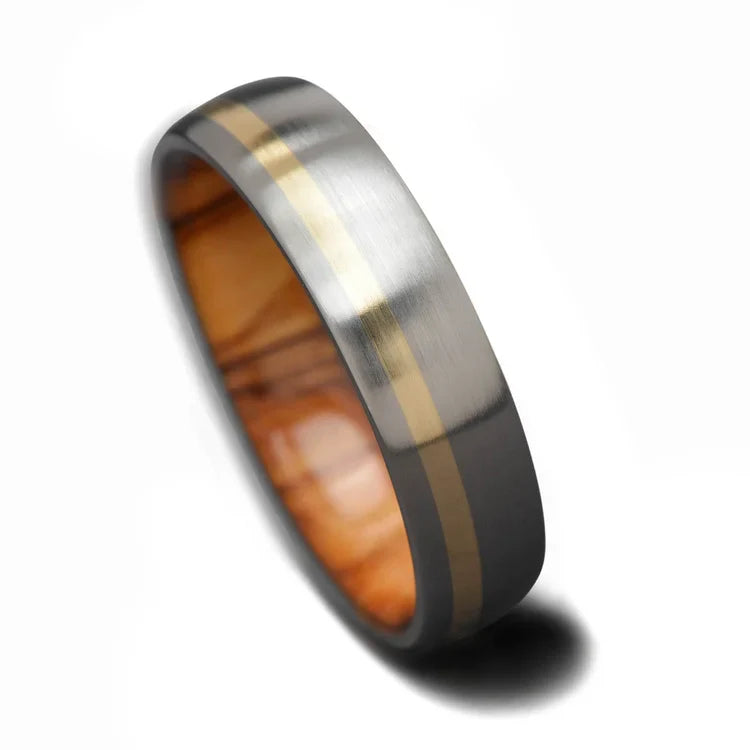 Titanium wedding band with 10KY gold and olivewood inlay, 6mm mens ring, unique brushed domed profile, free engraving option, displayed on a white background.