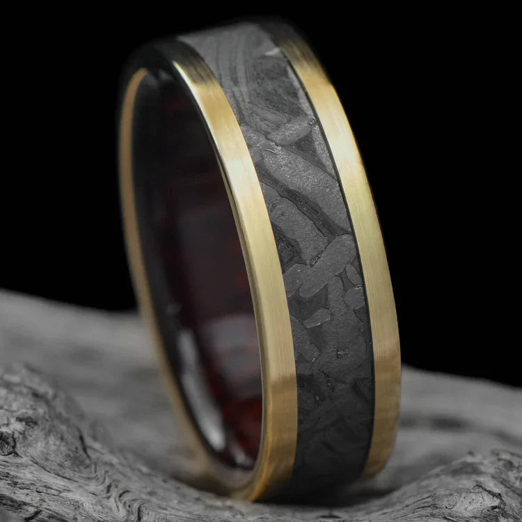14K yellow gold wedding band with meteorite and koa wood inlays, unique mens ring design, 7mm width, free engraving, displayed on white sea branch background.