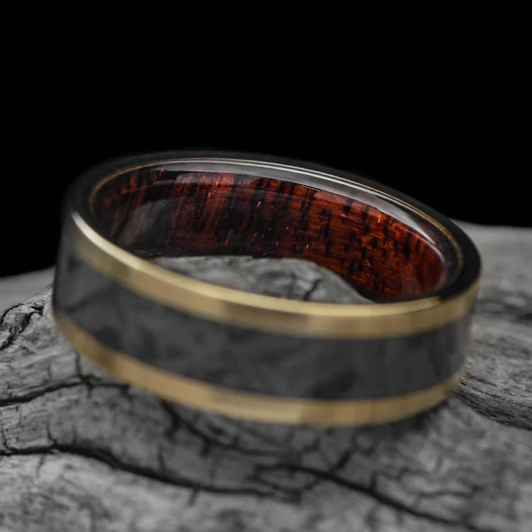 14K yellow gold wedding band with meteorite and koa wood inlays, 7mm mens ring, unique custom design, free engraving, displayed on a white sea branch.