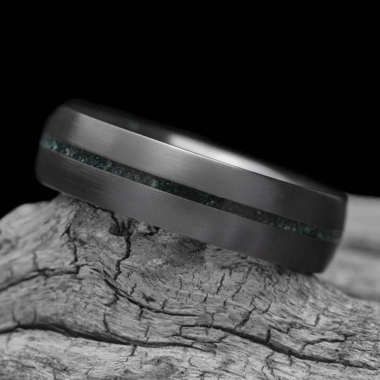 Zirconium wedding band with central moss agate inlay, 6mm mens ring, unique design, free engraving, displayed on a white sea branch.