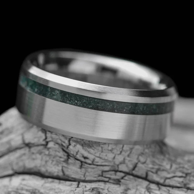 Titanium wedding band with moss agate inlay, 8mm mens ring, brushed bevel profile, unique design, free engraving, displayed on white sea branch.