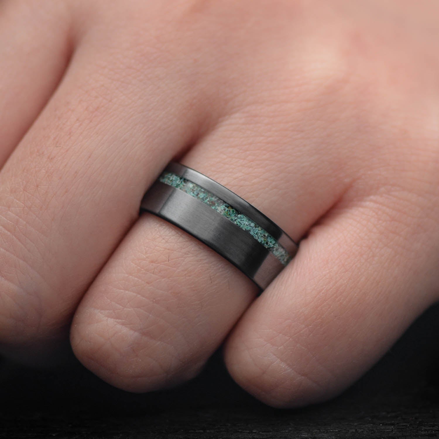 Black titanium mens wedding band with turquoise inlay, unique brushed finish, 8mm width, free engraving available, displayed on a white background.