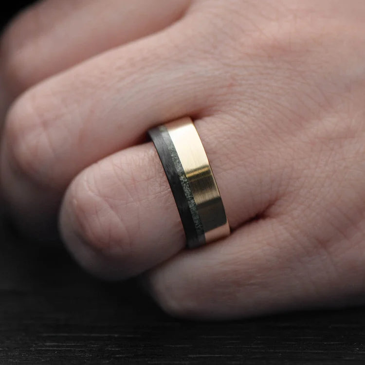 14KY gold mens wedding band with unidirectional and chrome diopside inlays, unique custom design, 8mm width, free engraving, displayed on a white sea branch.