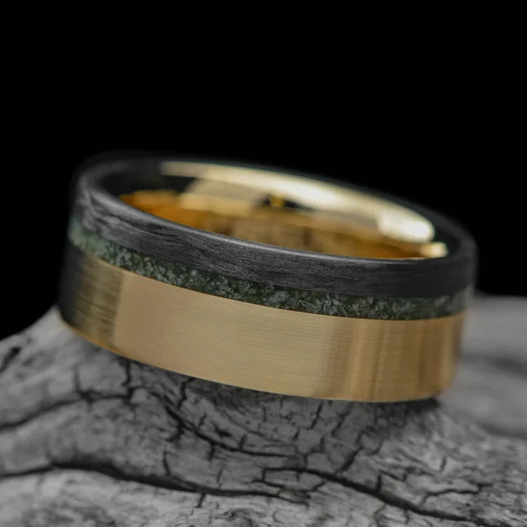 14KY gold mens wedding band with unidirectional and chrome diopside inlays, unique custom design, 8mm width, free engraving, displayed on a white sea branch.