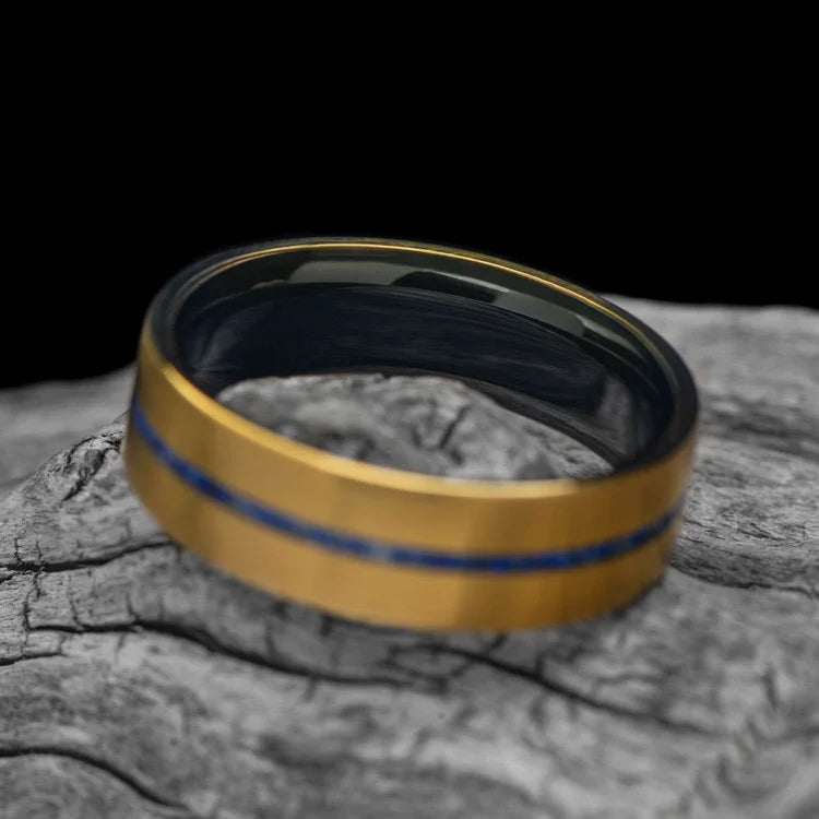 22KY gold wedding band with lapis lazuli inlay and African blackwood sleeve, 7mm mens ring, unique design, free engraving, displayed on white sea branch.