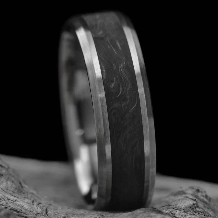 Titanium wedding band with central forged inlay, free engraving, 7mm mens wedding ring, brushed bevel profile, displayed on white sea branch.