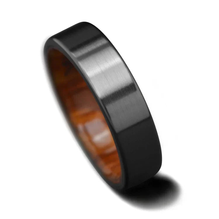Black titanium wedding band with silver spalted birch inner sleeve, 6mm mens ring, unique design, free engraving, displayed on a white background.
