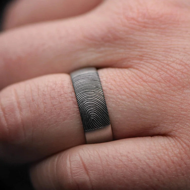 Titanium wedding band with sandblasted finish, 8mm mens domed profile ring, custom mens wedding band, free engraving, displayed on a white sea branch.