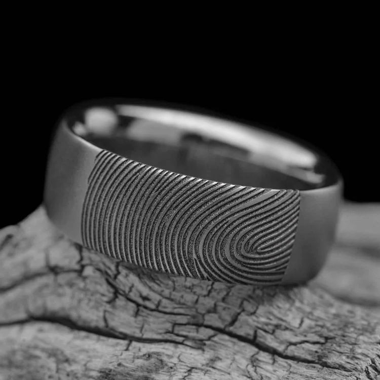 Titanium wedding band with sandblasted finish, 8mm mens domed profile ring, custom mens wedding band, free engraving, displayed on a white sea branch.