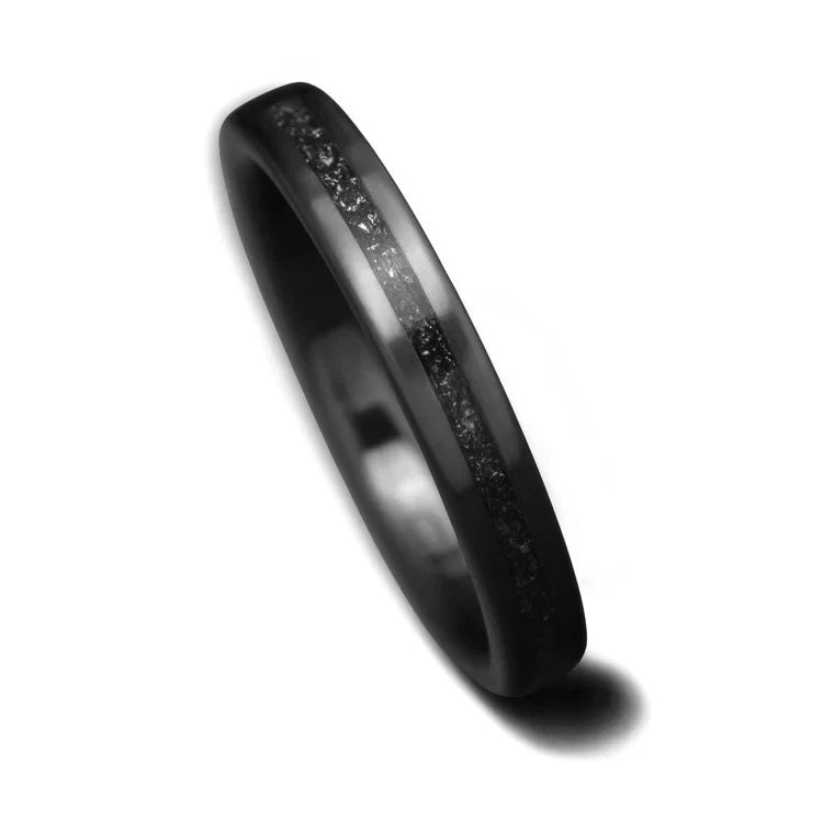 Womens 3mm Black Titanium wedding band with central meteorite inlay, unique custom ring with free engraving, displayed on a white background.