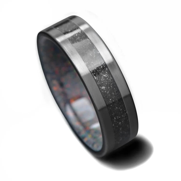Black Titanium Wedding Band with Meteorite and Sand Inlay, featuring a 7mm width and a Black Fire Opal inner sleeve, mens wedding ring, available with free engraving, displayed on a white background.