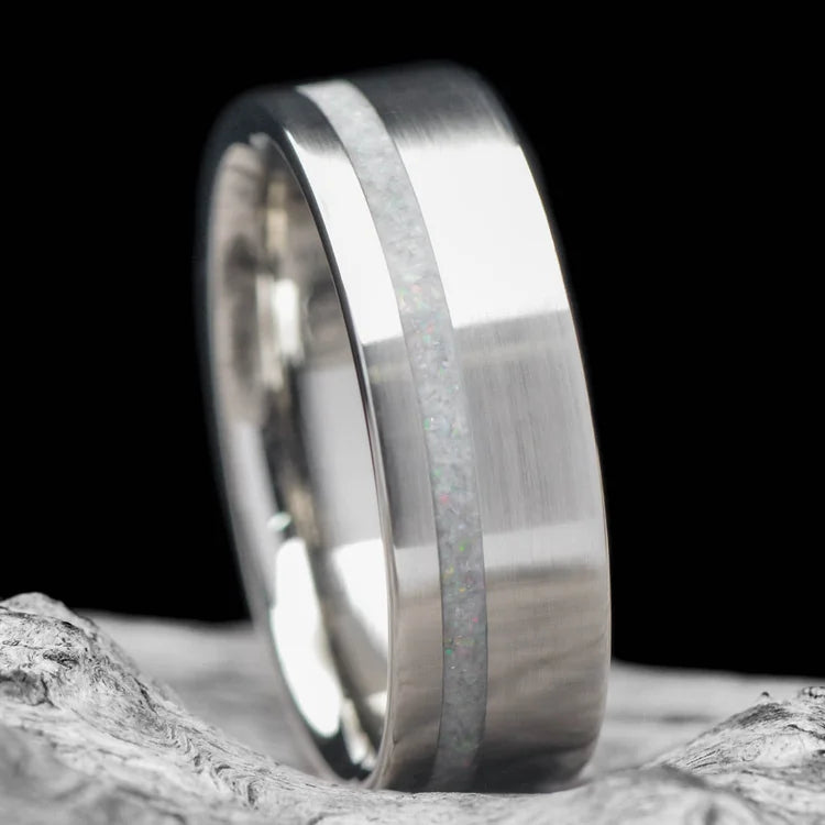 Mens 10KW wedding band with pearl inlay, 7mm brushed flat profile, custom design, free engraving, displayed on a white sea branch.
