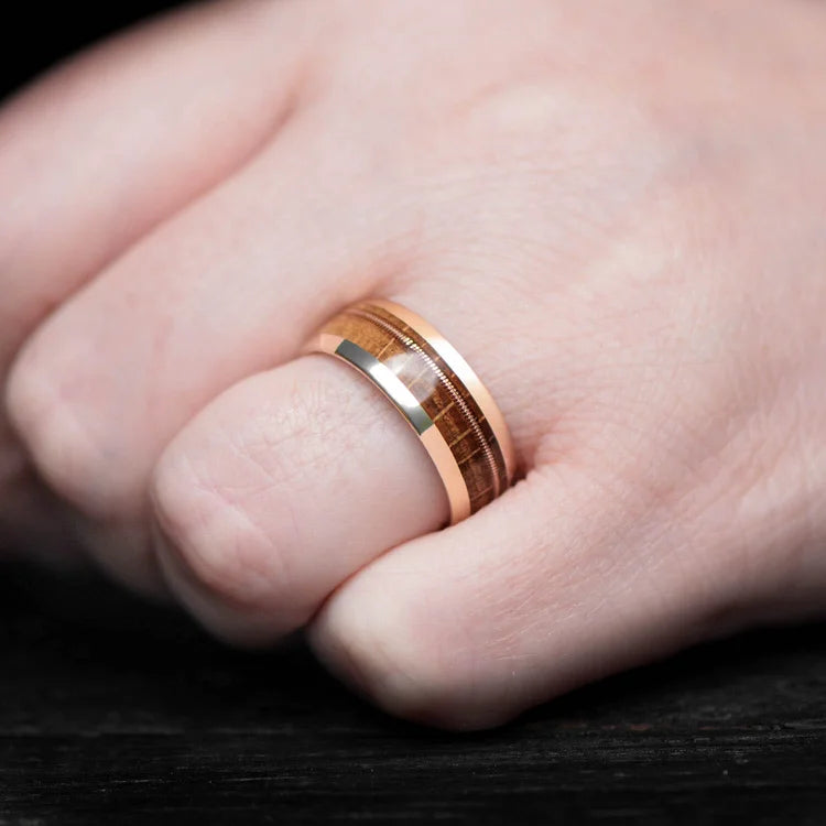 Mens 10KY Gold Wedding Band with Guitar String and Whiskey Barrel Oak Inlay, 8mm, featuring free engraving, worn on a hand, unique mens ring design.