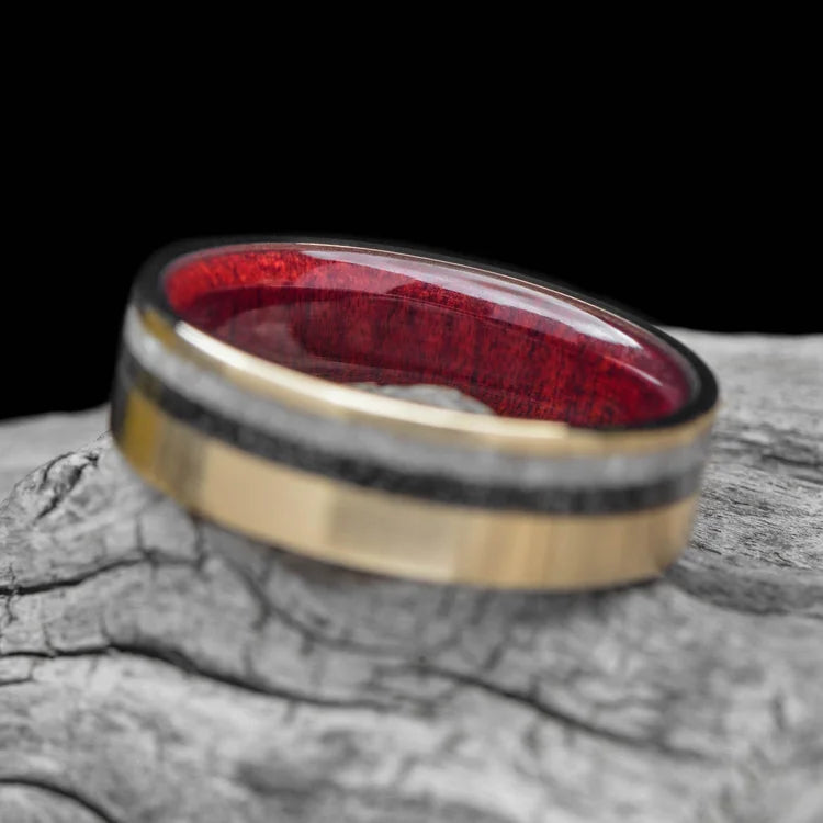14K yellow gold wedding band with pearl and meteorite inlays, bloodwood inner sleeve, 7mm mens ring, unique design, free engraving, displayed on white sea branch.