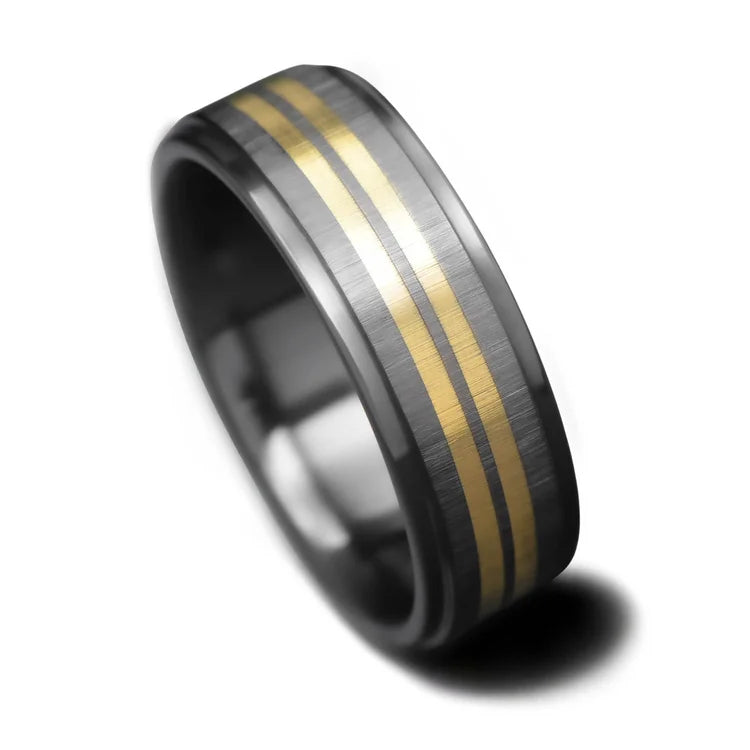Black titanium wedding band with dual 18K yellow gold inlays, featuring free engraving, 7mm width, brushed step profile, custom mens ring on a white background.