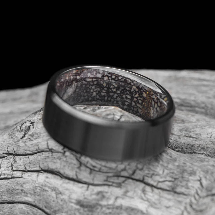 Black titanium wedding band with T-Rex inner sleeve, 8mm mens ring, unique design, free engraving option, displayed on a white background.