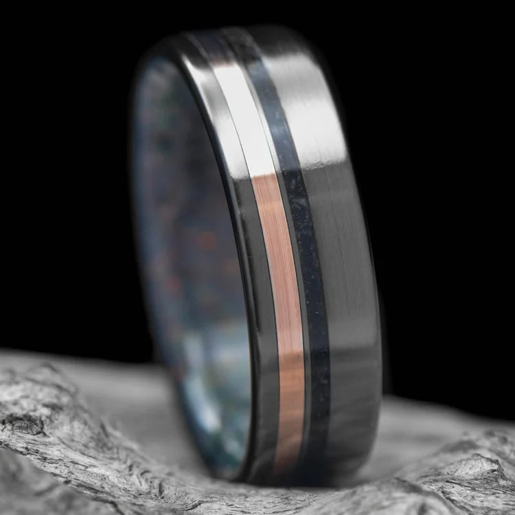 Black Titanium Wedding Band with 10K Rose Gold and Black Onyx Inlays, Black Fire Opal Inner Sleeve, 7mm Mens Wedding Ring, on White Sea Branch, Free Engraving Available.