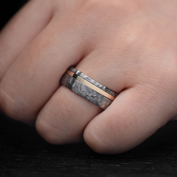 Mens faceted tantalum wedding band with 14K yellow gold inlay and inner sleeve, 8mm, unique design, free engraving, worn on a hand.