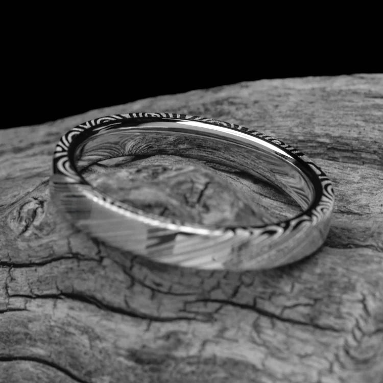 Heimskringla Wedding Band with 10KW Inner Sleeve on white sea branch, 4mm custom flat profile ring with polished finish, free engraving, simple elegant design.
