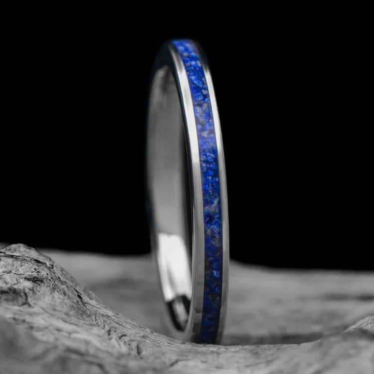 14KW womens wedding band with central lapis lazuli inlay, brushed flat profile, 2mm width, custom lapis ring, free engraving, displayed on a white sea branch.