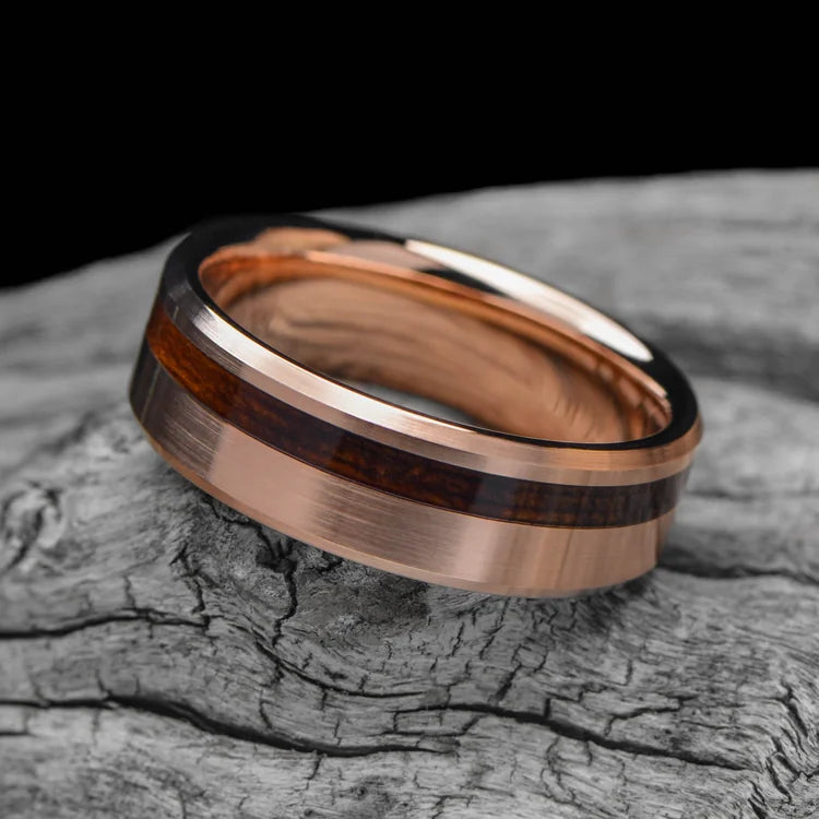 18K rose gold mens wedding band with teak wood inlay, brushed bevel profile, 7mm width, unique design, free engraving, displayed on white sea branch.