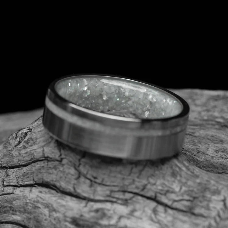 14KW mens wedding band with pearl inlay and brushed flat profile, 6mm, unique design, free engraving, displayed on a white sea branch.