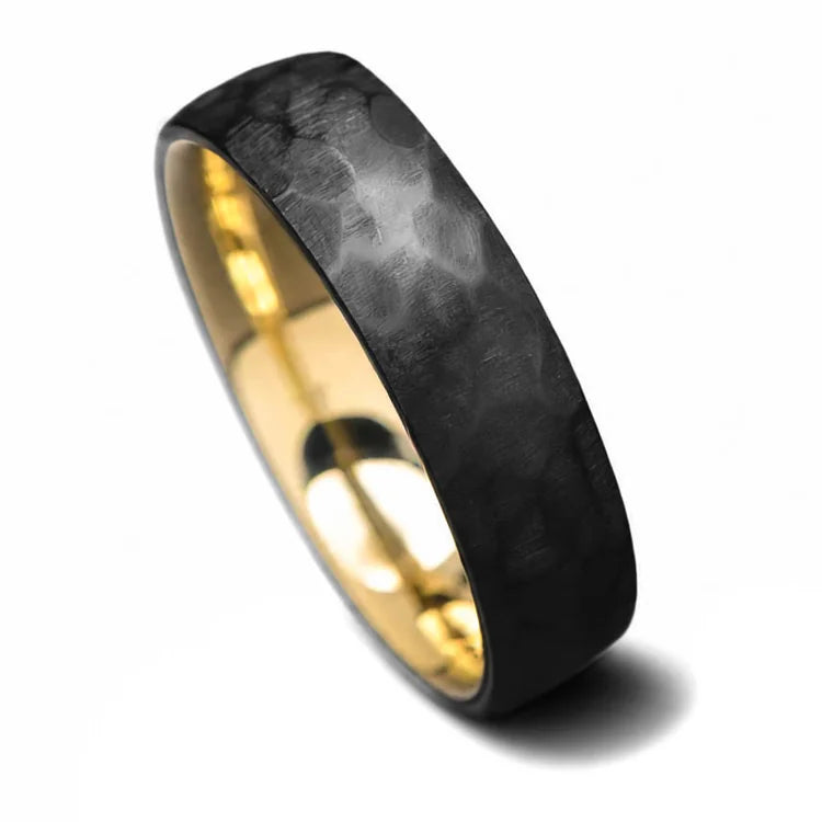 Black titanium wedding band with 14K yellow gold inner sleeve, featuring a faceted domed profile, 6mm width, mens unique wedding ring, available with free engraving, displayed on a white background.