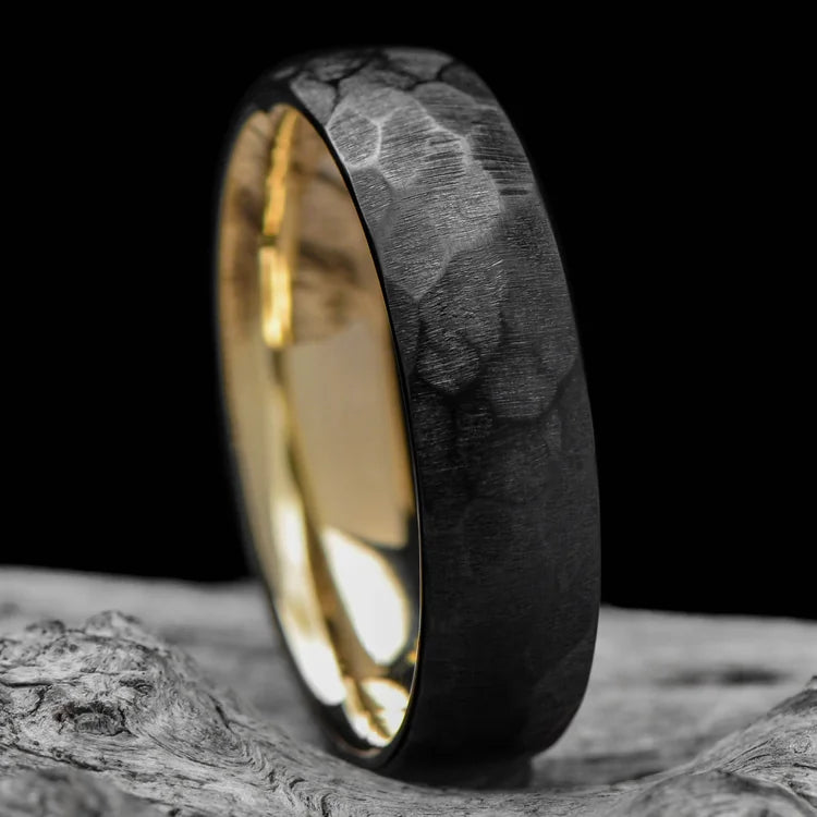Black Titanium Wedding Band with 14K Yellow Gold Inner Sleeve, Faceted Domed Profile, 6mm Mens Wedding Ring, Unique Design, Lying on White Sea Branch, Free Engraving Available