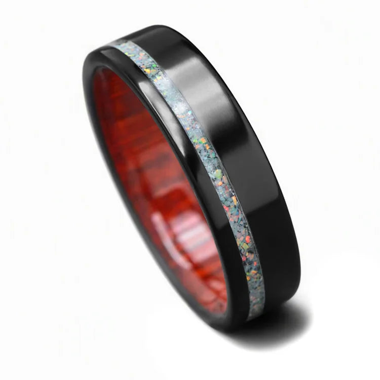 Black titanium mens wedding band with pearl opal inlay and bloodwood inner sleeve, featuring a polished flat profile, 6mm width, available with free engraving, displayed on a white background.