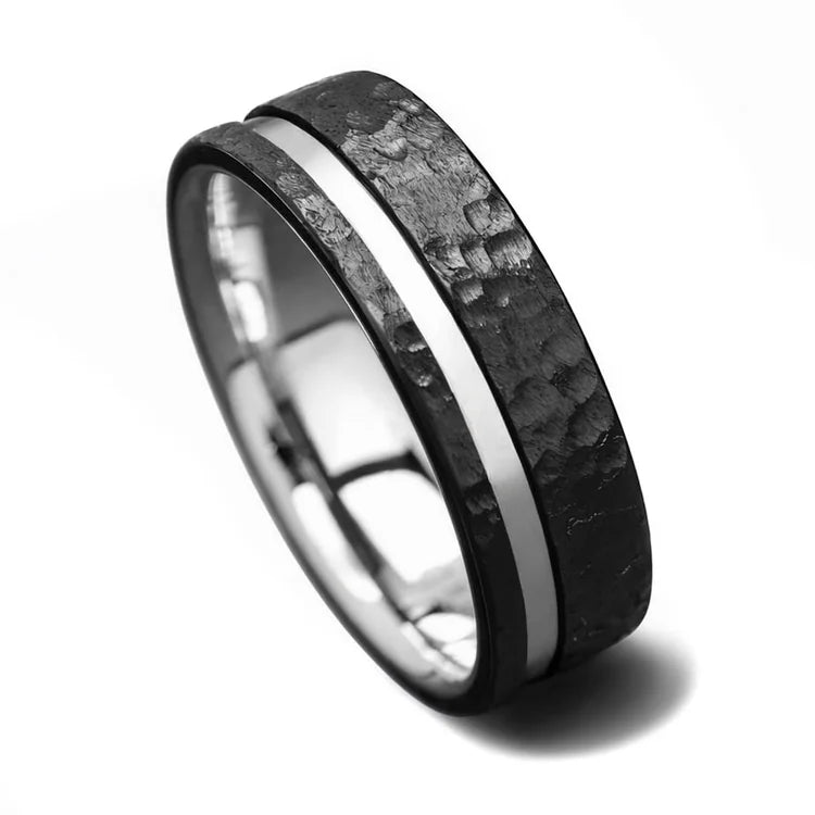 Black titanium wedding band with 14K white gold inlay and faceted finish, 7mm mens ring, unique design, free engraving available, on white background.