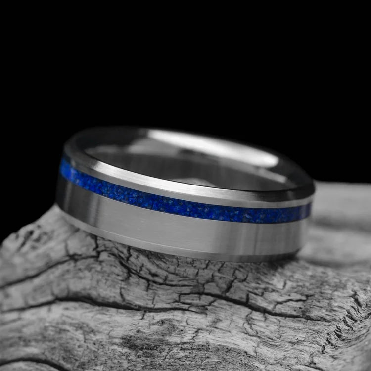 Titanium wedding band with lapis lazuli inlay, 7mm mens ring, brushed bevel profile, unique design, free engraving, displayed on white sea branch.