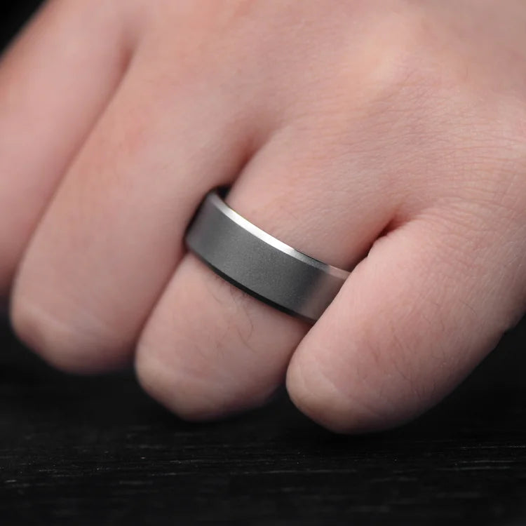 Mens titanium wedding band with moss agate inner sleeve, sandblasted bevel profile, 8mm width, unique design, free engraving, worn on a hand.