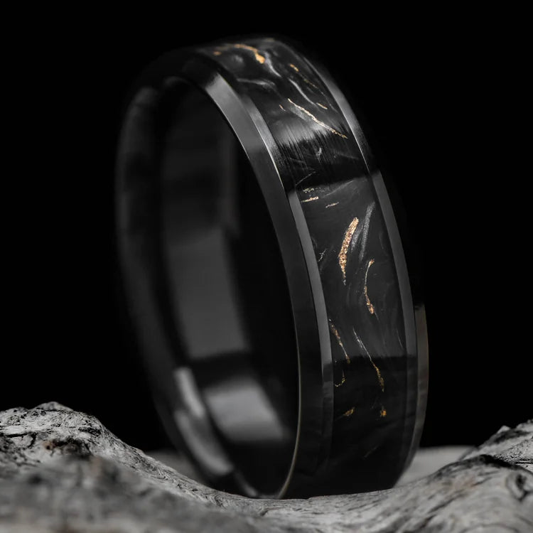 Black titanium ring with gilded forged inlay, 7mm mens wedding band, polished bevel profile, unique design, displayed on white sand beach background.